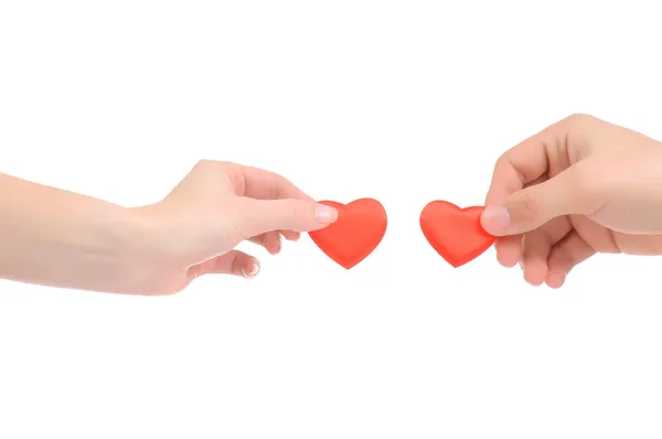 Coeur rouge dans les mains des femmes et des hommes, isolé sur blanc — Photo