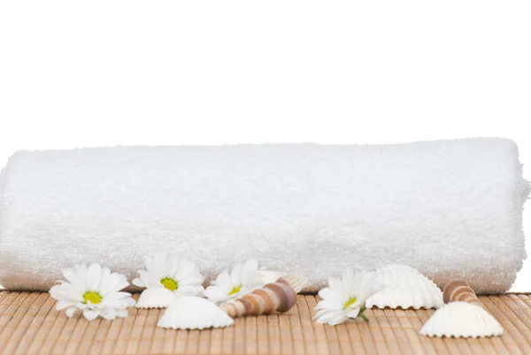 Ręcznik i rumianek kwiaty na bambus na białym tle — Zdjęcie stockowe