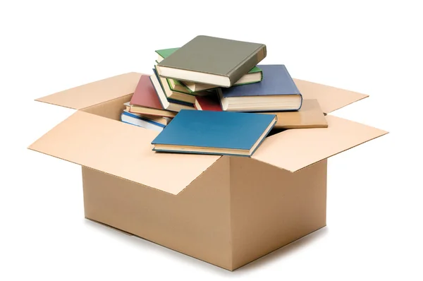 Caja de cartón y libros aislados en blanco — Foto de Stock