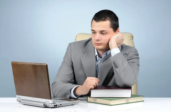 Tired businessman in the books — Stock Photo, Image