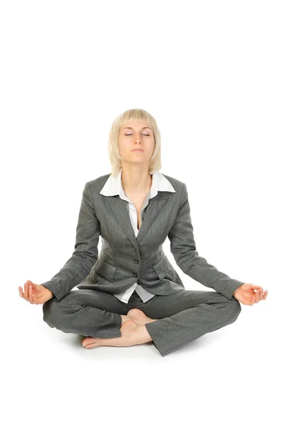 Woman sitting in lotus position isolated on white background — Stock Photo, Image