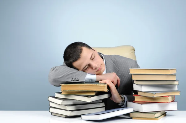 Tired businessman and books — Stock Photo, Image