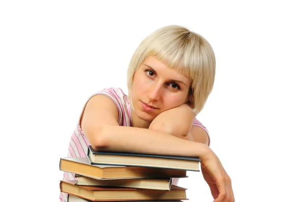 Jonge vrouw met boek heap — Stockfoto