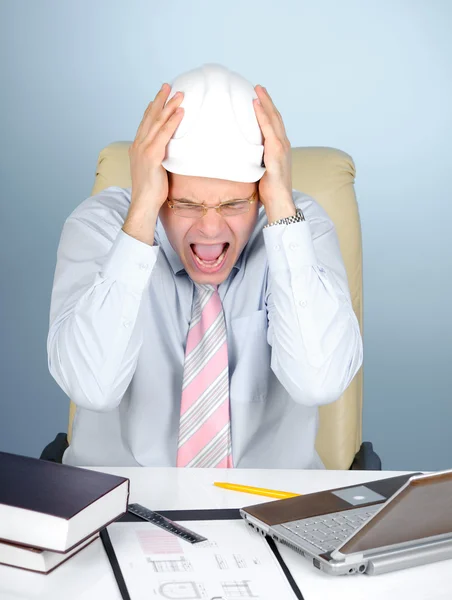 Crazy engineer with a white hard hat at work — Stock Photo, Image