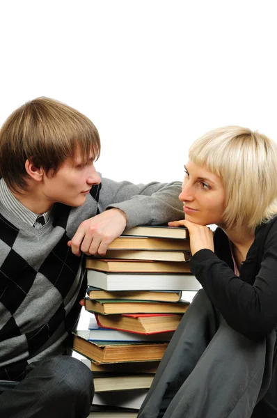 Young couple with stack of books isolated on white background Stock Image