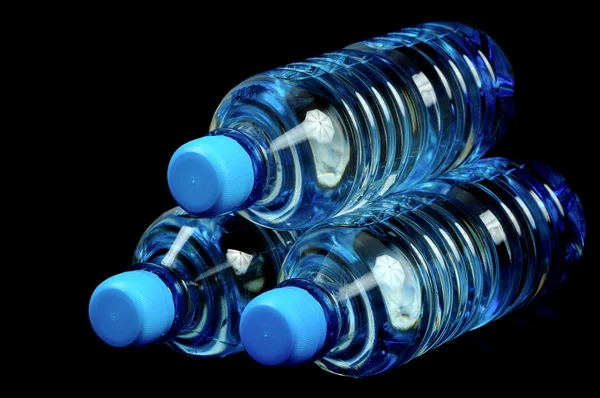 Bottled water isolated over a black background — Stock Photo, Image