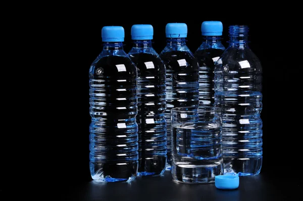 Bottled water isolated over a black background — Stock Photo, Image