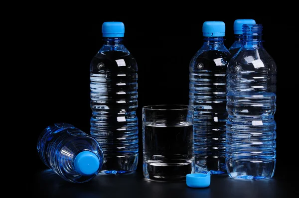 Bottled water isolated over a black background — Stock Photo, Image