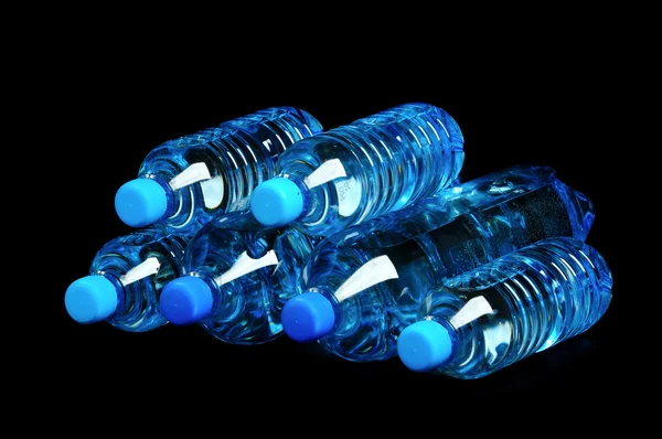 Bottled water isolated over a black background — Stock Photo, Image