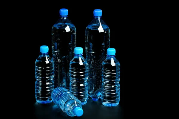 Bottled water isolated over a black background — Stock Photo, Image