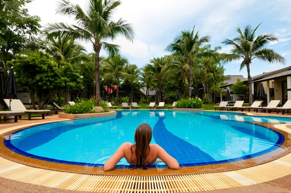 Woman relaxing in swimming pool