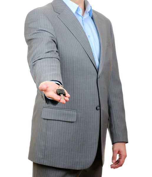Бизнесмен держит ключ изолирован на белом фоне — стоковое фото
