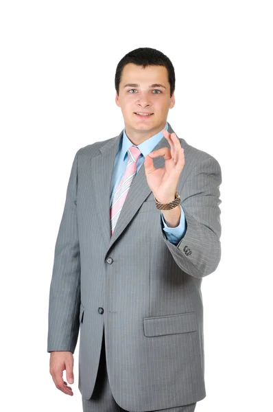 Счастливый улыбающийся веселый молодой бизнесмен с нормальным жестом — стоковое фото