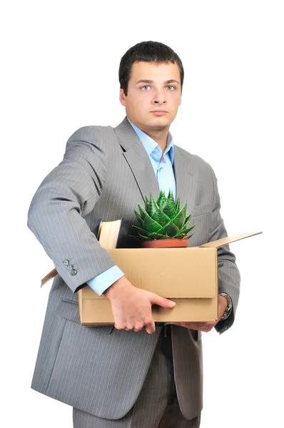 Ты уволен! Молодой бизнесмен держит картонную коробку с личными вещами на белом фоне — стоковое фото