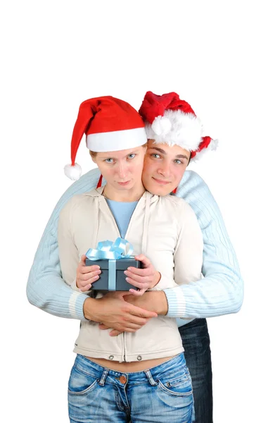 Young couple in santa's hats holding gift boxes isolated on white background Stock Image
