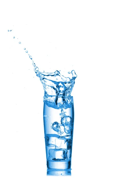 Вода бризкає в склянці на білому тлі — стокове фото