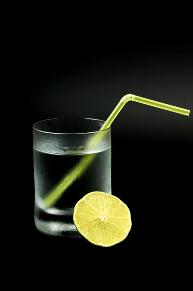 Fresh cocktail in frozen glass and half of lime — Stock Photo, Image