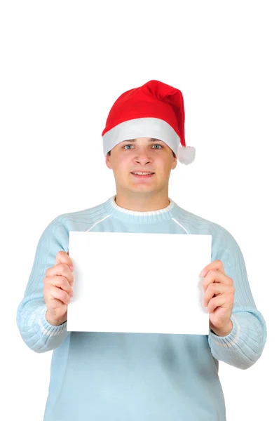 Young man in santa's hat holding empty blank card isolated on white background — Stock Photo, Image