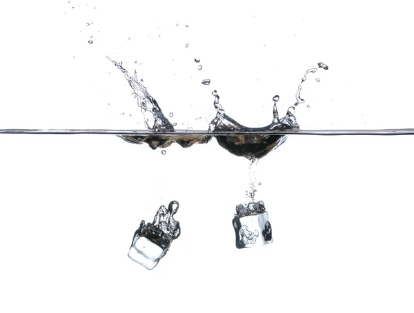 Ice cubes falling into water. Water splash Stock Photo