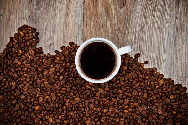 Cup of coffee on the coffee beans — Stock Photo, Image