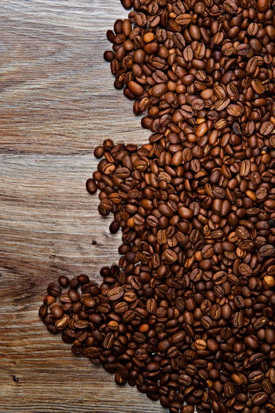 Coffee beans on grunge wooden background — Stock Photo, Image