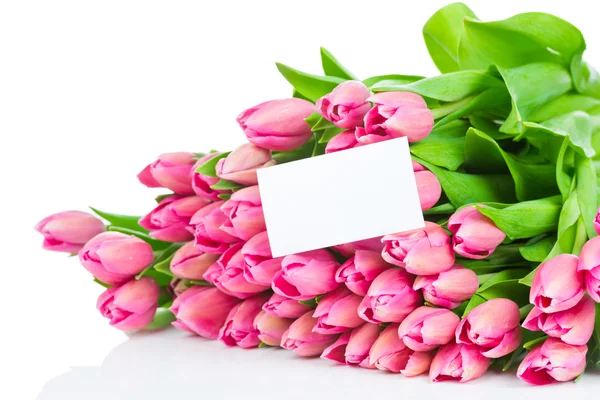 Bukett av rosa tulpaner och ett gratulationskort — Stockfoto