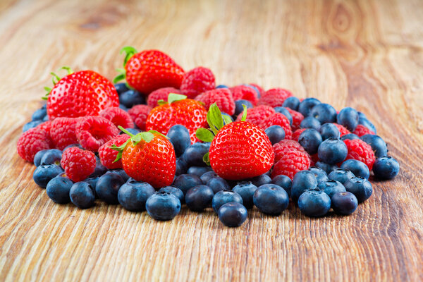 Berries on wooden background