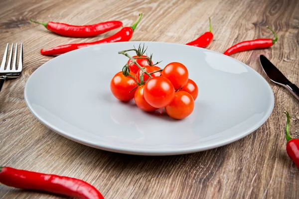Red hot chili peppers and tomatoes — Stock Photo, Image