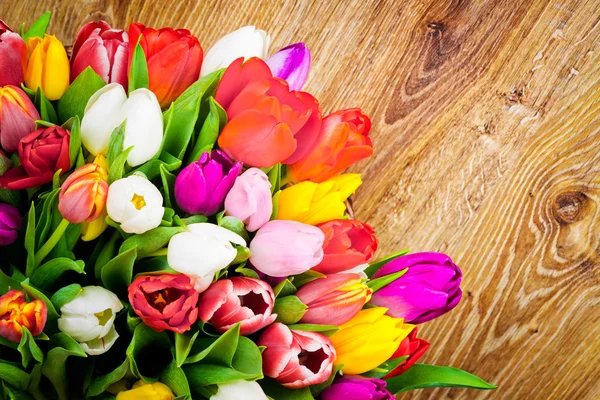 Tulips on wooden background — Stock Photo, Image