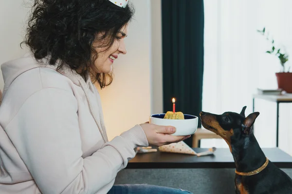 Happy Young Girl Giving Homemade Cake Her Dog Indoors Concept — Stock Photo, Image