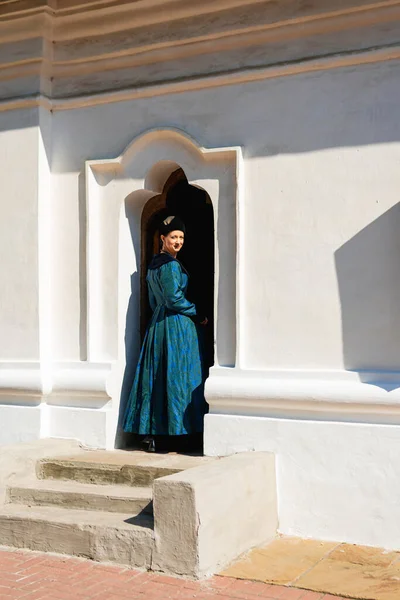 Portrait of woman dressed in blue historical Baroque clothes with old fashion hairstyle, outdoors. Luxurious medieval dress