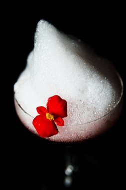 Alcoholic drink. A cocktail with elite alcohol on dark black background, close-up. Concept of  nightlife and exotic drinks.