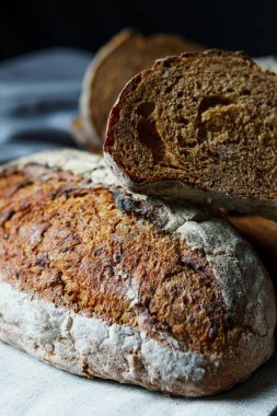 Freshly baked bread with a golden crust close up. Yeast dough. Concept of bakery products, bakery and healthy eating