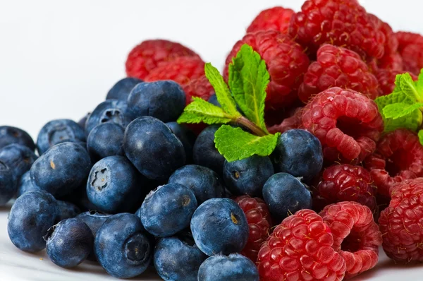 Blueberry and ruspberry berries with mint leaves — Stock Photo, Image