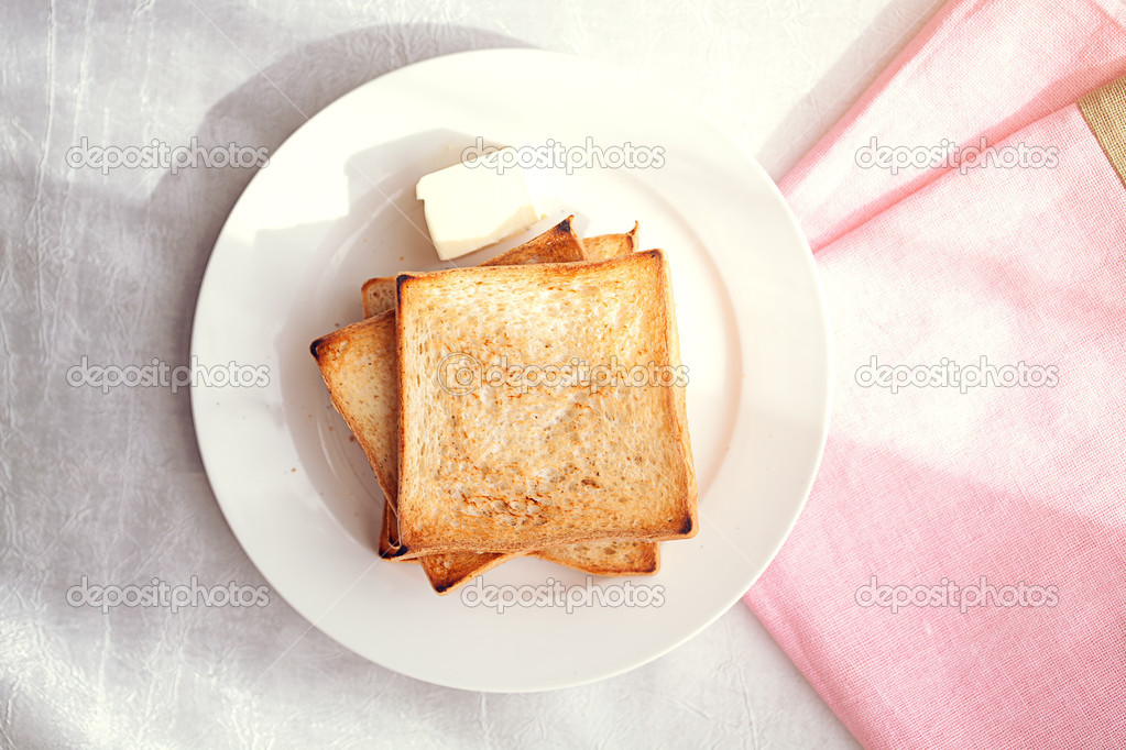 Toasted bread slices with butter pat for breakfast