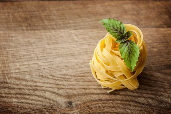 Pasta fresh basil on wood — Stock Photo, Image