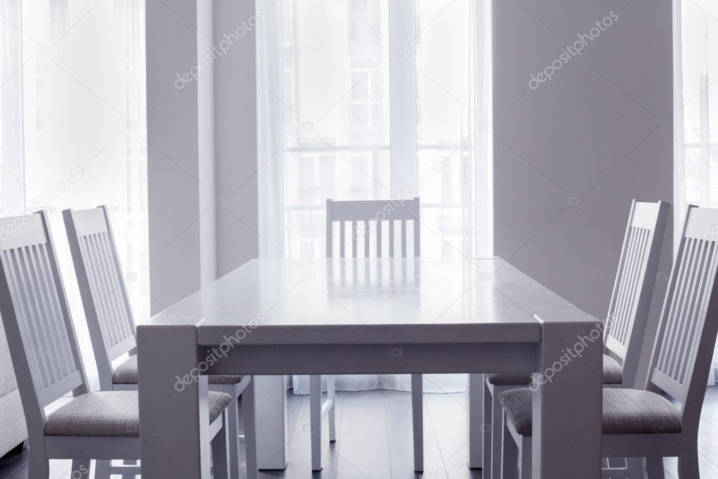 Interior of white kitchen with table