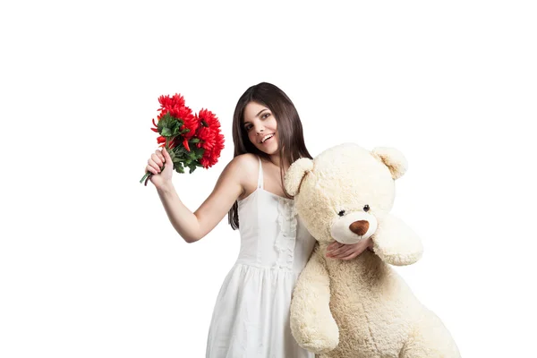 Woman with Teddy bear and flowers — Stock Photo, Image