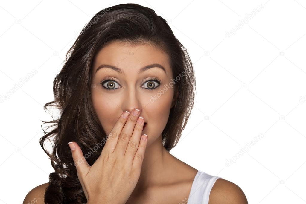 Amazed  girl with hand over mouth