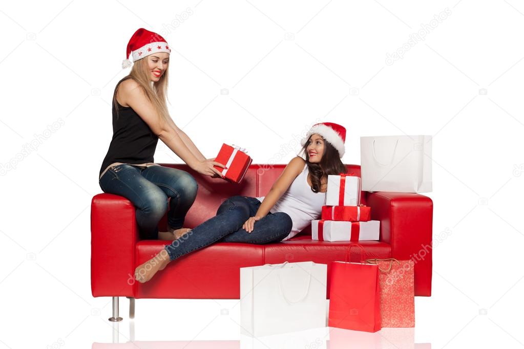 Girl friends   surrounded by shopping bags and gifts