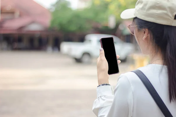 Close up view of women hand holding smartphone with blur background on black screen of on phone with copy space for business or social media internet  communication of technology