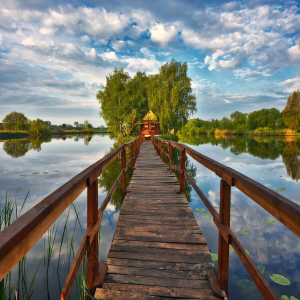 small house on the island. bridge on a picturesque lake. nature of Ukraine