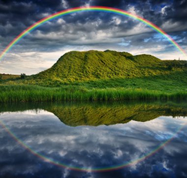 Landscape with a Rainbow on the River in Spring. colorful morning. nature of Ukraine