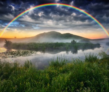 Landscape with a Rainbow on the River in Spring. colorful morning. nature of Ukraine