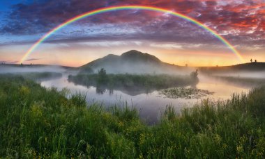 Landscape with a Rainbow on the River in Spring. colorful morning. nature of Ukraine