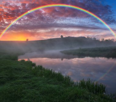 Landscape with a Rainbow on the River in Spring. colorful morning. nature of Ukraine