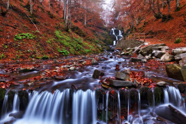 picturesque waterfall in the autumn forest. Nature of Ukraine