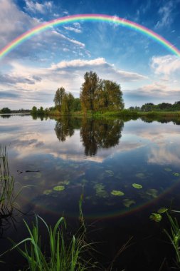 Landscape with a Rainbow on the River in Spring. colorful morning. nature of Ukraine