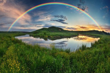 Landscape with a Rainbow on the River in Spring. colorful morning. nature of Ukraine