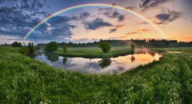Landscape with a Rainbow on the River in Spring. colorful morning. nature of Ukraine